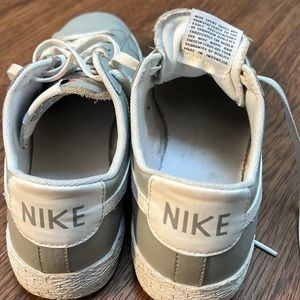 Gray and white Nike court shoes.